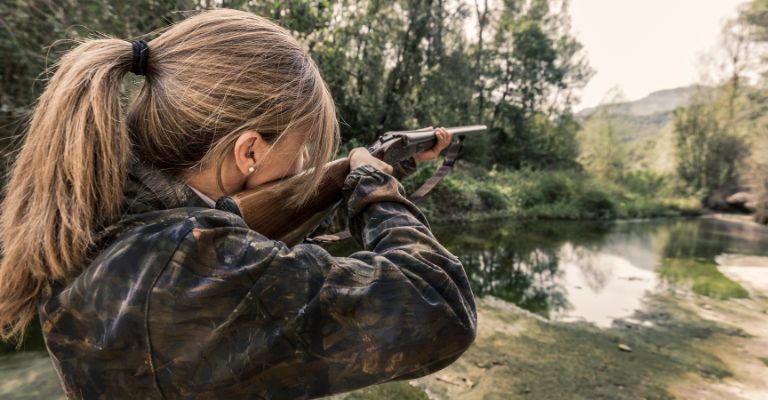 female hunter taking aim